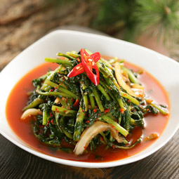 Spicy young summer radish kimchi with greens